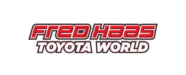 Logo for Fred Haas Toyota World with red lettering outlined in black and white.